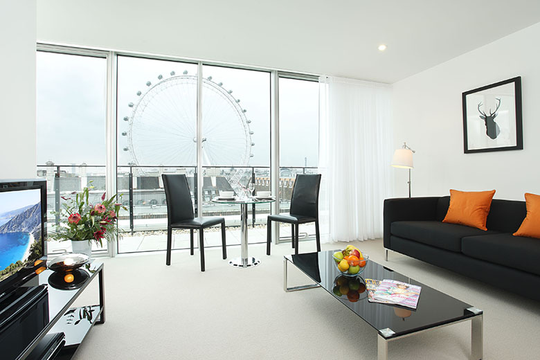 A bright, modern lounge with views of the London Eye