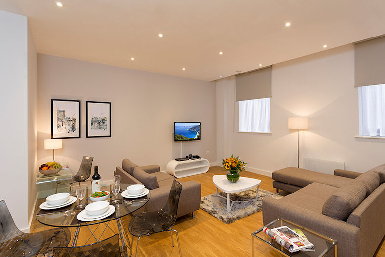 A spacious, smart living and dining area at Picadilly Place Apartments