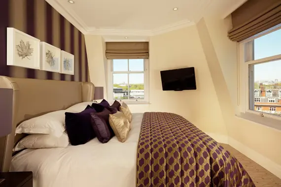 A grand bedroom in the Minsters Deluxe One Bedroom Suite