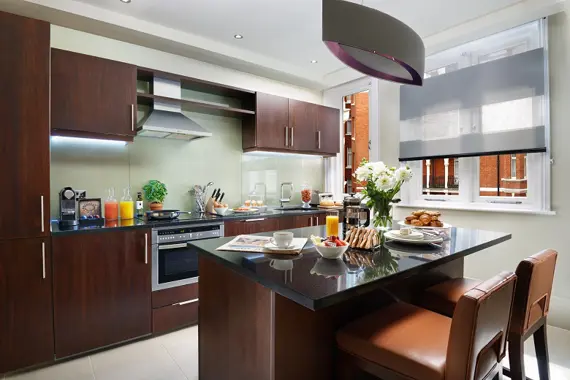 A fully equipped kitchen in a Kings Three Bedroom Suite