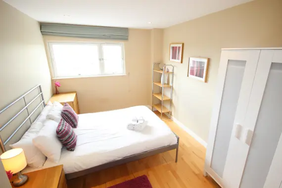 A warm, bright bedroom in a two bedroom apartment