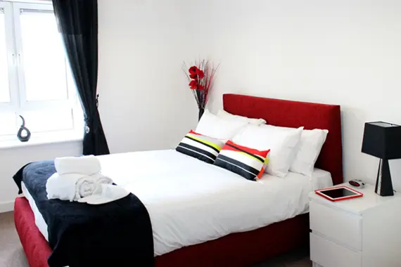 A bright, comfortable bedroom in a two bedroom apartment