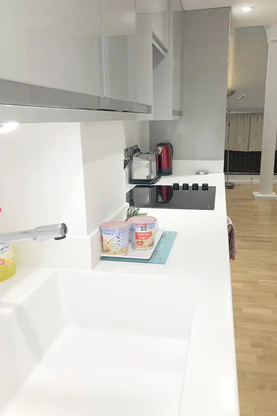 The slick Corian worktops in the stylish kitchen give plenty of space to prepare meals