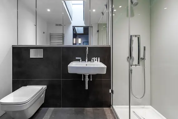 A modern tiled shower room in a one bedroom duplex