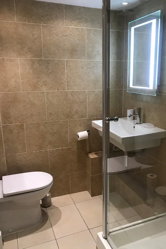 A bright beige tiled bathroom