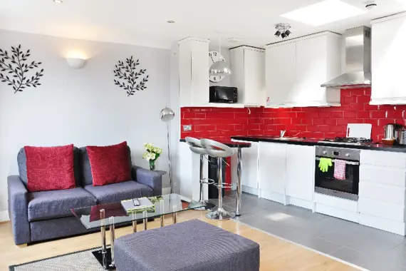 A bright red open plan kitchen and lounge area
