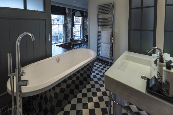 Black and white tiled bathroom in a Deluxe One Bedroom
