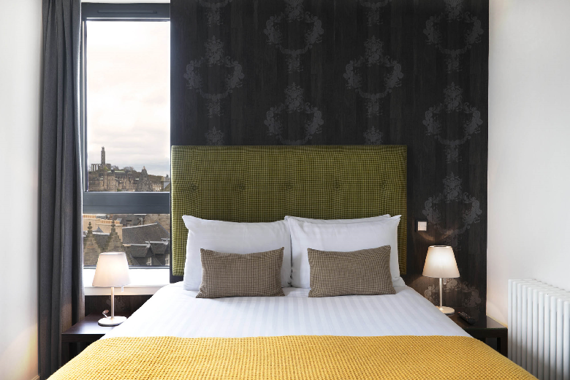 A spacious and bright bedroom area with views