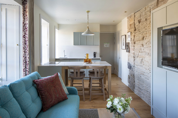 A beautiful lounge area with an open plan kitchen