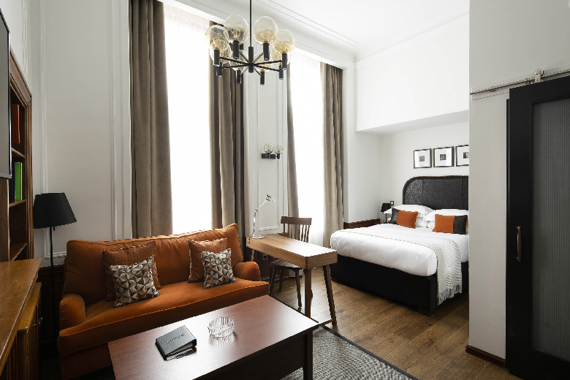 A deluxe open plan studio apartment with bright furniture