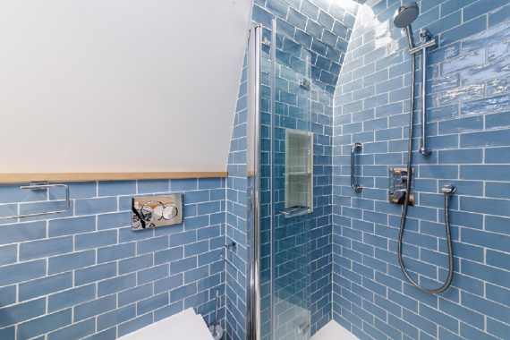 Blue tiled relaxing shower room