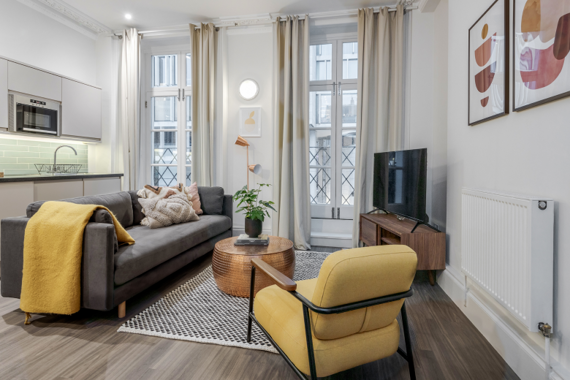 The living room boasts a light and modern aesthetic