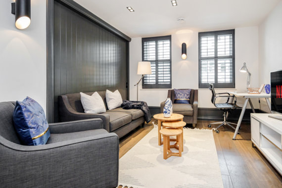 The living room boasts a light and cozy aesthetic