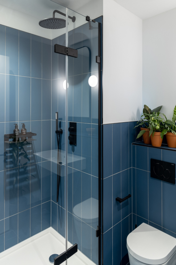 A polished and clean blue tiled bathroom