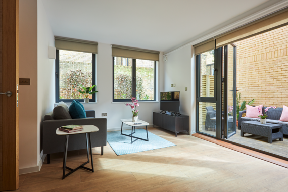 A spacious and bright lounge area with direct access to balcony