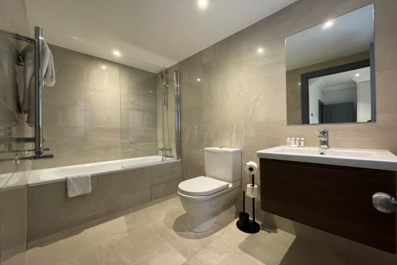 Modern and stylish bathroom, featuring sleek fixtures and a refreshing ambiance