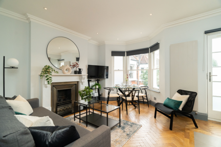 Comfortable and inviting living room, furnished with plush seating for relaxation and entertainment