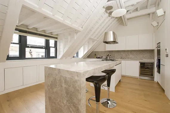 A bright, modern kitchen area with breakfast bar
