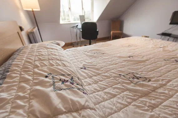 The comfortable bedroom has a handy study area