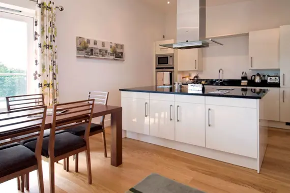 A modern and open plan dining area and kitchen at The Hamiltons