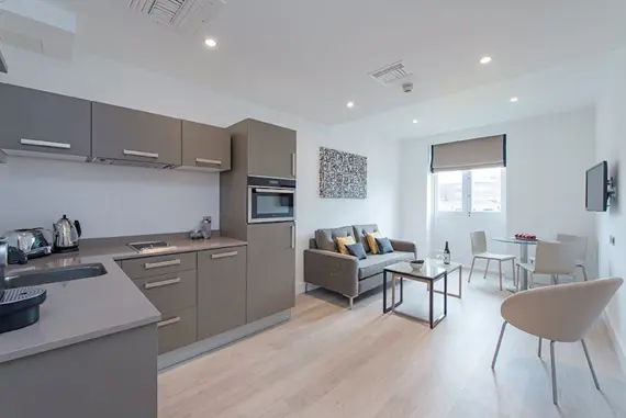 The stunning, light open-plan kitchen and living area in a one bedroom suite