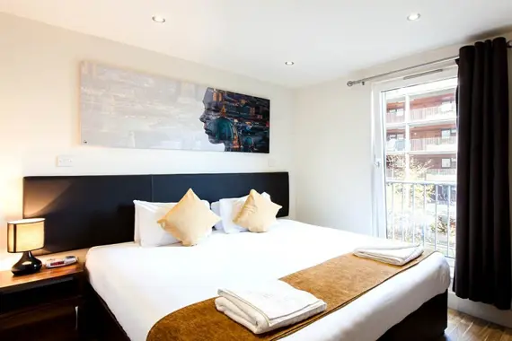 A comfortable bedroom, filled with light