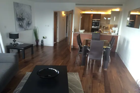A typical open plan kitchen and living area with a dining table for four