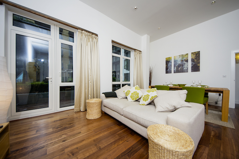 A bright and spacious living area at Kew Bridge Piazza with a large comfortable sofa