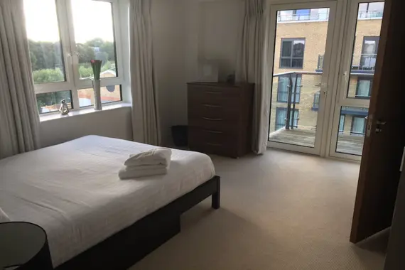 A bright and spacious double bedroom leading to a beautiful balcony