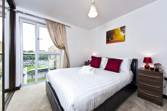 A spacious double bedroom at Kings Island with large windows and filled with natural light