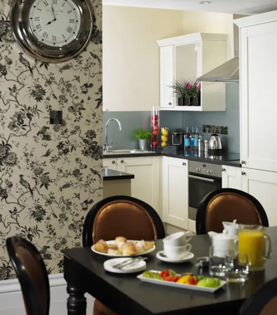 A stylish, well-equipped kitchen and dining area in the Diamond Suite