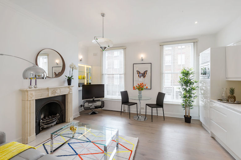 A well furnished living and dining area with fireplace at Crawford Street