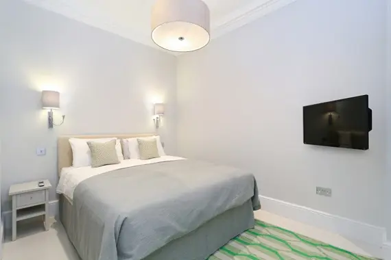 A grand, very comfortable looking bed in a three bedroom standard apartment