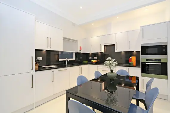 A spacious, sleek kitchen in a three bedroom standard apartment