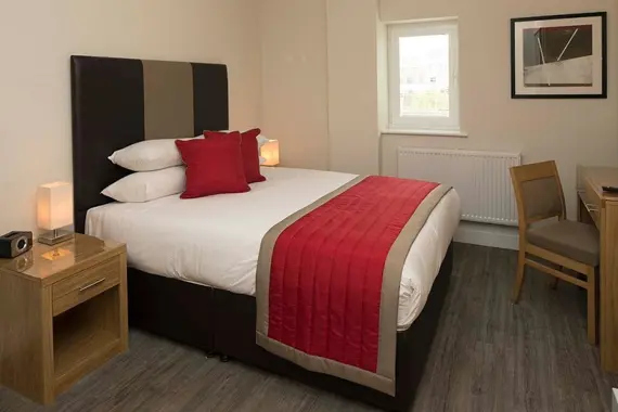 A comfortable bedroom with the addition of a work space