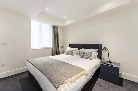 A bright, monochrome bedroom in the penthouse