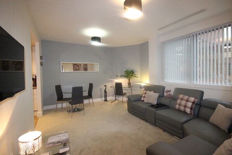 The spacious living room with dining area and work desk