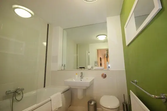A bright, modern bathroom in an executive two bedroom apartment