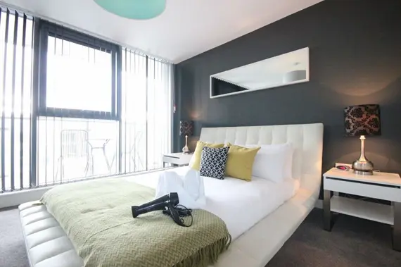 A chic, modern bedroom in a two bedroom executive apartment