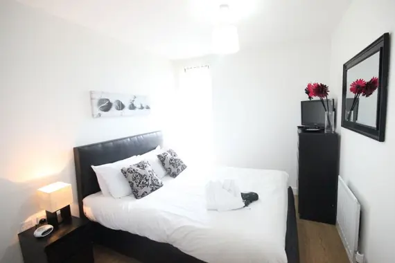 A modern double bedroom in an executive one bedroom apartment