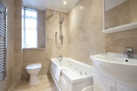 A sleek, spacious bathroom in the three bedroom apartment